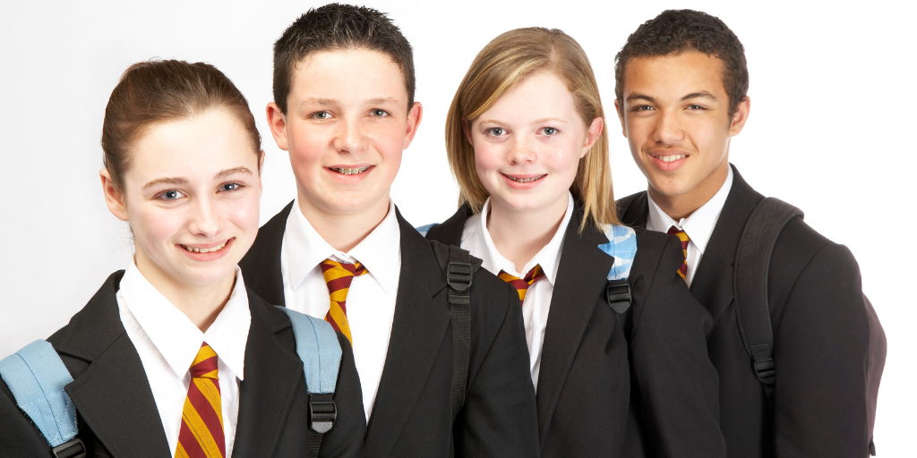 Four students wearing school uniforms